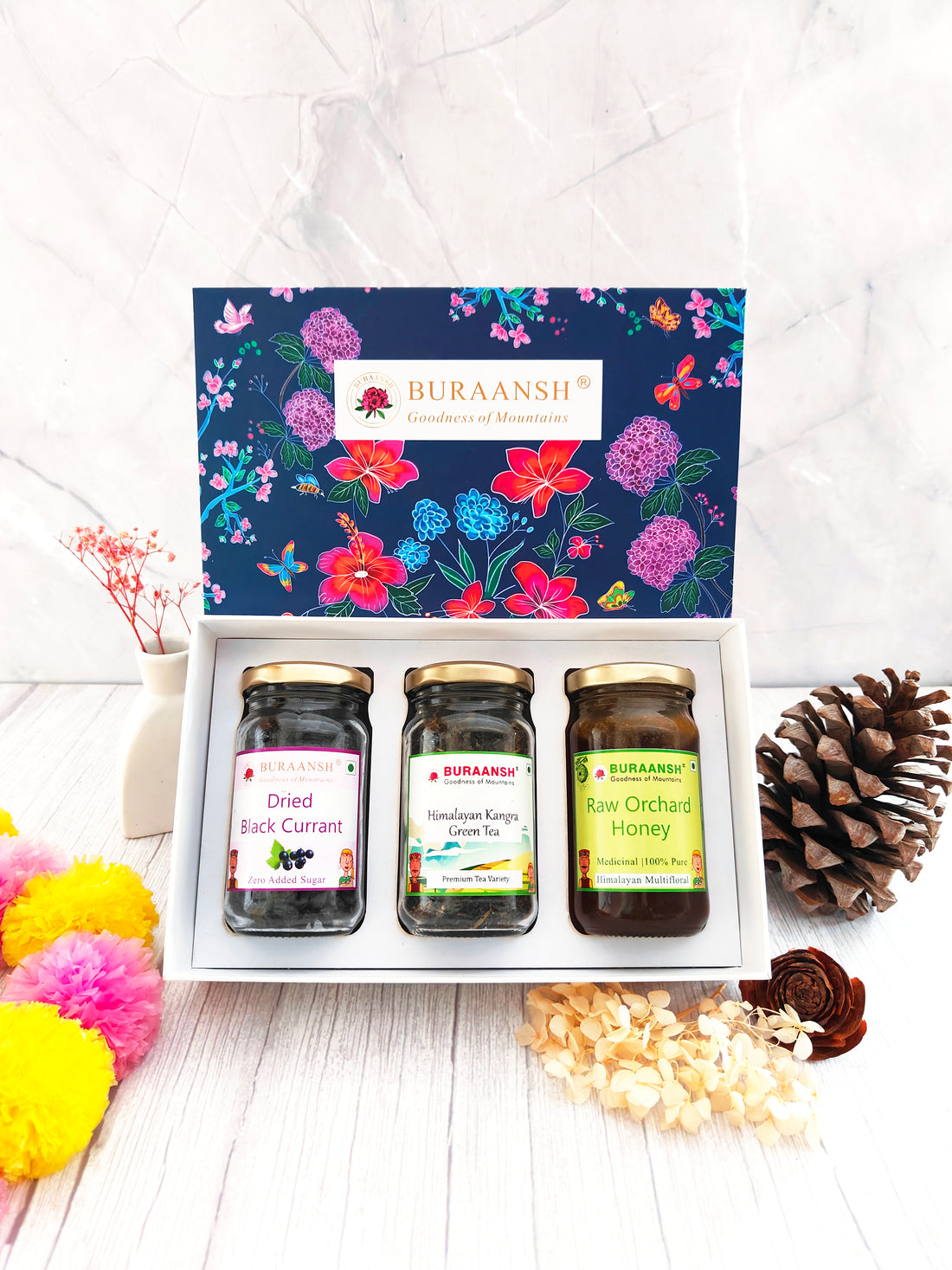 Beautiful Floral Diwali Festive Gift Box with Dried Black Currants, Himalayan Kangra Green Tea and Raw Orchard Honey in a glass bottle.