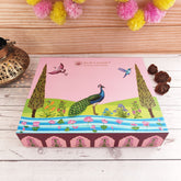 Decorative box with peacock design on a wooden surface with decorative elements.